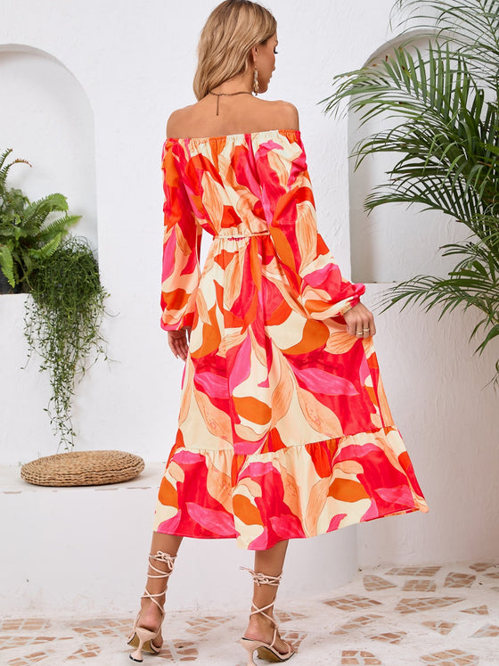 Back view of the Printed Long Sleeve Midi Dress showcasing its vibrant prints, tied waist, and off-shoulder neckline.