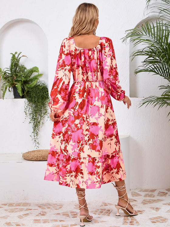 Back view of the Printed Long Sleeve Midi Dress showcasing its vibrant prints, tied waist, and off-shoulder neckline.