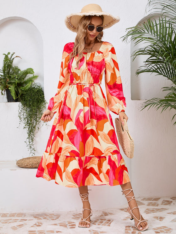 Front view of the Printed Long Sleeve Midi Dress showcasing its vibrant prints, tied waist, and off-shoulder neckline.