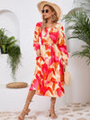 Front view of the Printed Long Sleeve Midi Dress showcasing its vibrant prints, tied waist, and off-shoulder neckline.