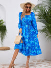 Front view of the Printed Long Sleeve Midi Dress showcasing its vibrant prints, tied waist, and off-shoulder neckline.