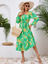 Front view of the Printed Long Sleeve Midi Dress showcasing its vibrant prints, tied waist, and off-shoulder neckline.