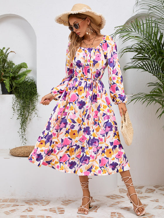 Front view of the Printed Long Sleeve Midi Dress showcasing its vibrant prints, tied waist, and off-shoulder neckline.