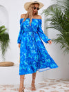 Front view of the Printed Long Sleeve Midi Dress showcasing its vibrant prints, tied waist, and off-shoulder neckline.