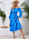 Side view of the Printed Long Sleeve Midi Dress highlighting the tiered hem and elegant long sleeves.