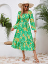 Side view of the Printed Long Sleeve Midi Dress highlighting the tiered hem and elegant long sleeves.