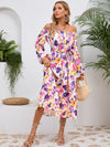 Side view of the Printed Long Sleeve Midi Dress highlighting the tiered hem and elegant long sleeves.