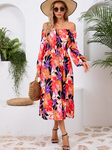  Woman wearing a Printed Long Sleeve Midi Dress featuring a tied waist, off-shoulder neckline, and vibrant print, perfect for casual outings or evening wear.