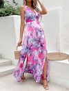 Woman wearing a chic printed sleeveless maxi dress with an open back, halter neck, and thigh-high slit, perfect for summer outings.