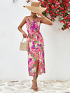 Model wearing the Printed Spaghetti Strap Front Slit Dress styled with a sun hat for a chic summer look.