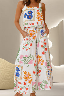  Model wearing a vibrant floral printed two-piece set featuring a square neck top and wide-leg pants, styled for casual summer occasions.

