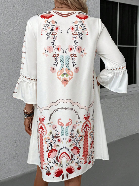 Back view of the off-white dress, gently lit to show structure and how the print extends seamlessly across the back panel.


