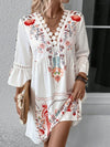 Model wearing the off-white printed dress in a front-facing pose, highlighting the soft palette and flowy elegance of the material.

