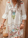 Tan dress shown front-facing with hands on hips, showcasing the structured yet breezy fit ideal for daytime wear.

