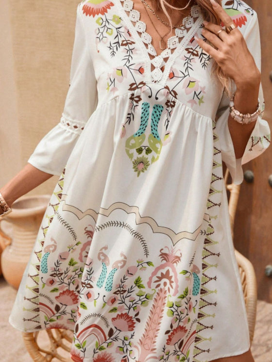 Front view in soft lighting, capturing the earthy tones of the tan print and subtle detailing around the neckline and hem.

