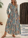 Model wearing a Printed Tie Neck Long Sleeve Maxi Dress with a paisley print, featuring a tie neckline and flowy silhouette, perfect for boho-inspired casual or semi-formal occasions.