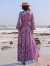 Back view of the maxi dress showcasing the paisley print and elegant flow.