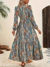 Back view of the Printed Tie Neck Long Sleeve Maxi Dress, highlighting the tie neck design and flowy skirt.