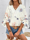  Model styled in a printed white blouse with short sleeves, captured in a front portrait view perfect for online fashion lookbooks.
