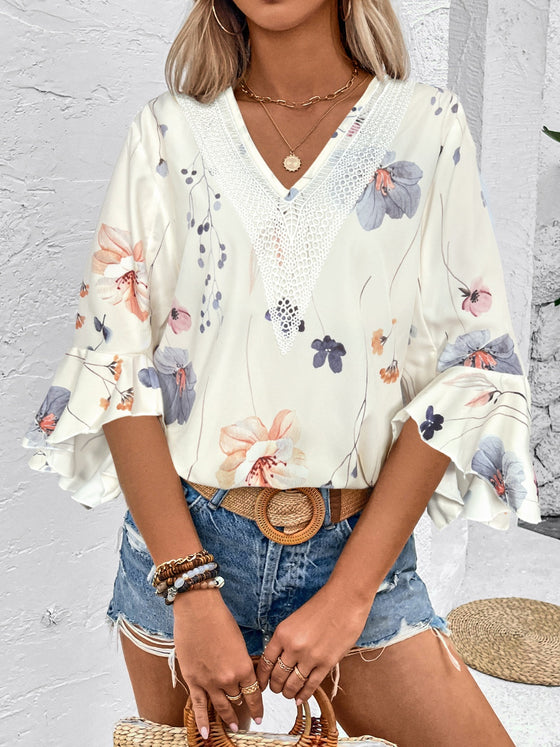  Model styled in a printed white blouse with short sleeves, captured in a front portrait view perfect for online fashion lookbooks.