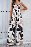 Front view of the Printed Wide Strap Jumpsuit with Pockets, showcasing an abstract white print on a navy background.