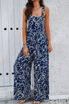 Front view of the Printed Wide Strap Jumpsuit with Pockets, showcasing an abstract white print on a navy background.