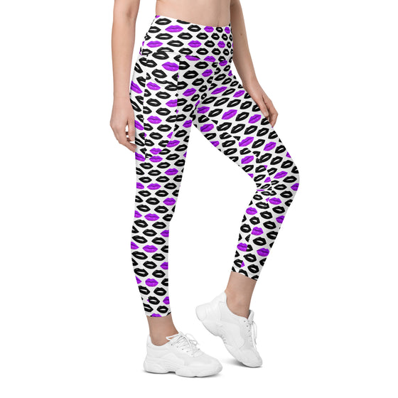 Front view of woman wearing white leggings with pop-art purple and black lips print. High waist compression leggings with side pockets for women.