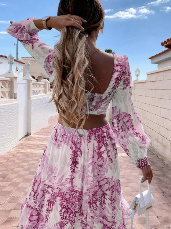 Back close-up of the purple dress showcasing the delicate tie-back closure above the cutout and cascading ruffles that fall gracefully over the upper back and shoulders.