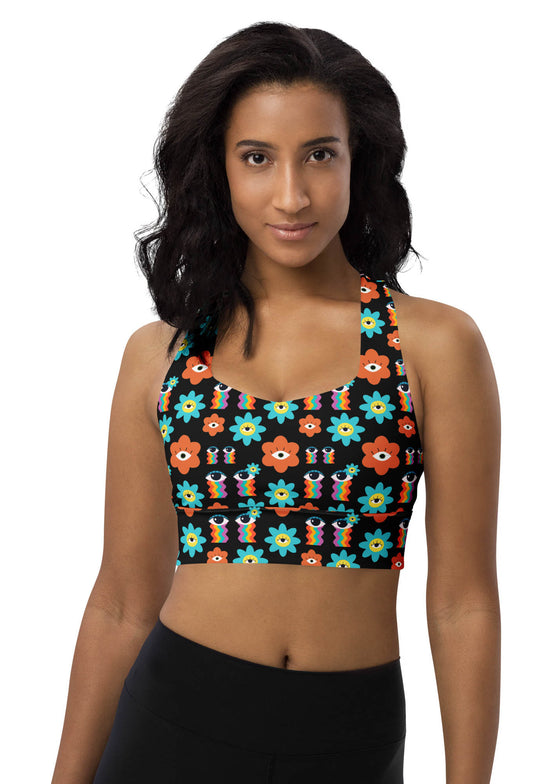 Woman wearing the Rainbow Eyes Print Black Longline Racerback Sports Bra. Stylish and supportive with a vibrant floral design, longline cut, and racerback fit for gym workouts and yoga.