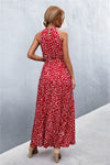 Back view of red sleeveless printed maxi dress with a flowing hem—classic and eye-catching choice for weekend plans or getaways.