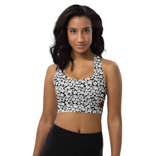  Woman wearing a high-support racerback sports bra with a black & white rose print, perfect for high-impact workouts. Offers excellent support for gym and active wear.