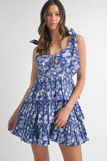  Close front view of the royal blue floral mini dress featuring delicate floral patterns and a perfectly tailored bodice that flatters the neckline.