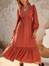 Front view of the Ruched V-Neck Long Sleeve Midi Dress in a warm rust color, showcasing its flattering fit and flowy design.