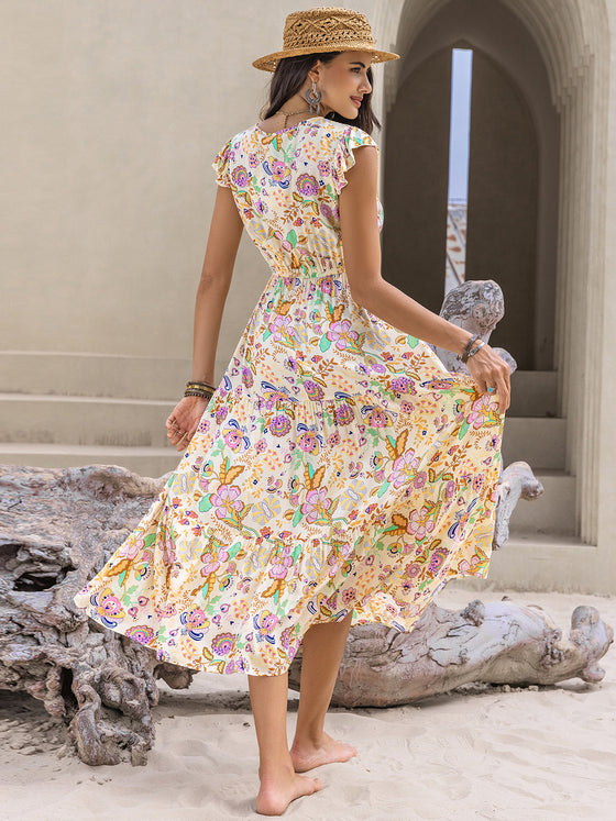 Back view of the Ruched Printed Cap Sleeve Midi Dress with vibrant floral and paisley print.