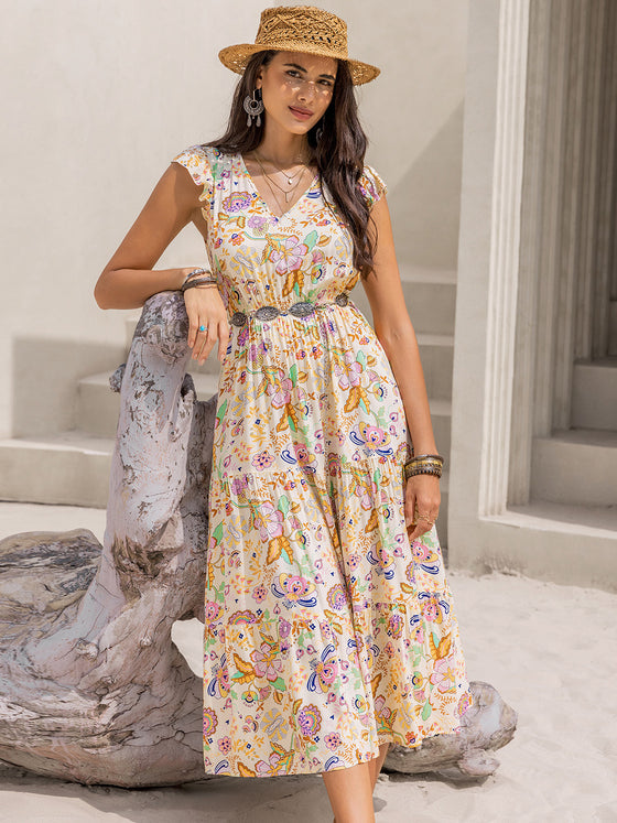 Model wearing the Ruched Printed Cap Sleeve Midi Dress styled with boho accessories, perfect for a summer day.