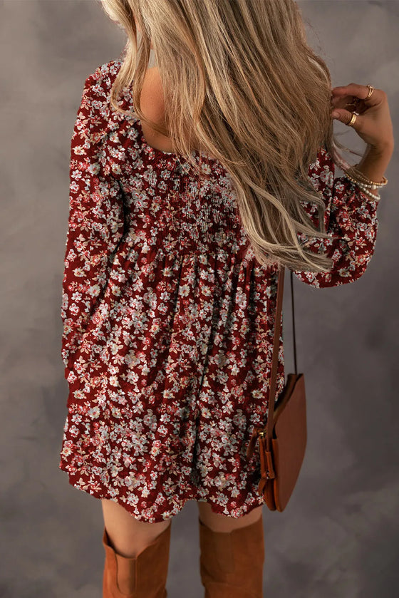 Back view of Ruched Printed Long Sleeve Mini Dress with flowy design and floral print.