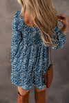 Back view of Ruched Printed Long Sleeve Mini Dress with flowy design and floral print.