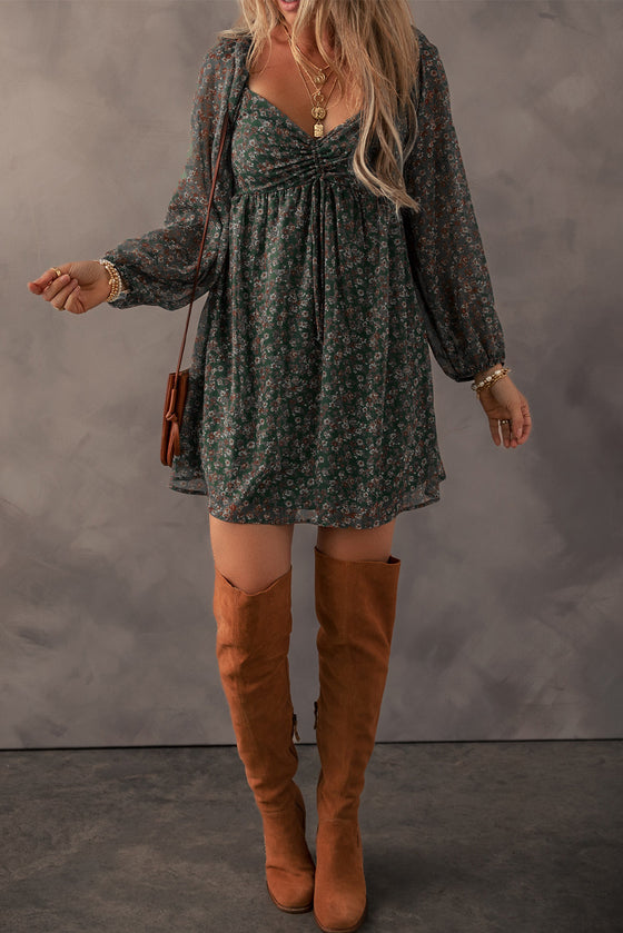  Front view of Ruched Printed Long Sleeve Mini Dress with floral print and ruched bodice.