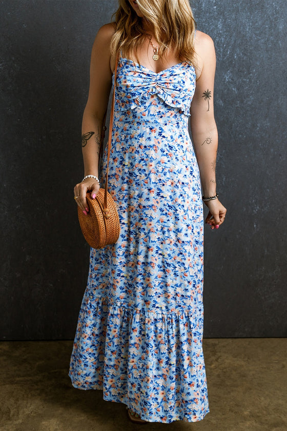 Woman wearing a Ruched Ruffle Hem Printed Cami Dress with a floral design, ruched bust, and flowing ruffle hem.

