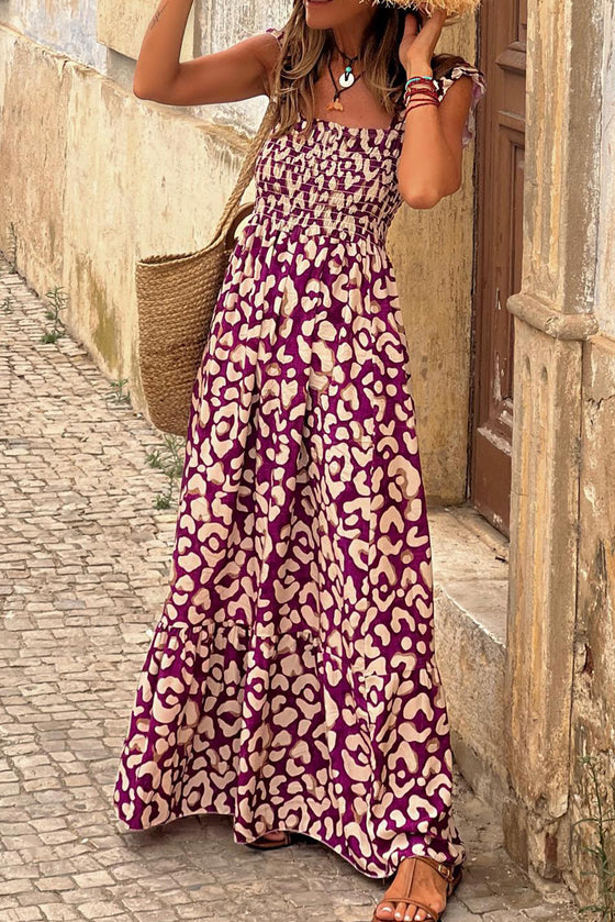 Woman wearing a vibrant Ruffled Printed Wide Strap Maxi Dress with a breezy fit, wide straps, and playful ruffle detailing, perfect for summer outings.