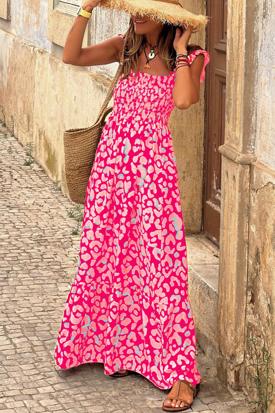 Woman wearing a vibrant Ruffled Printed Wide Strap Maxi Dress with a breezy fit, wide straps, and playful ruffle detailing, perfect for summer outings.