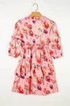 Back view of the Ruffled Printed Tie Neck Mini Dress with a tie neckline and floral print, perfect for casual outings.