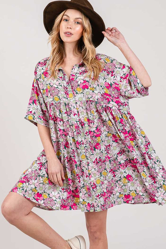 Woman wearing the SAGE + FIG Floral Button Down Mini Shirt Dress featuring a charming floral print, ruched details, and a button-down front for a versatile style.