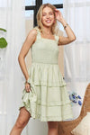 A relaxed and breezy front view of this flowy mini dress, perfect for warm-weather outings and casual elegance.