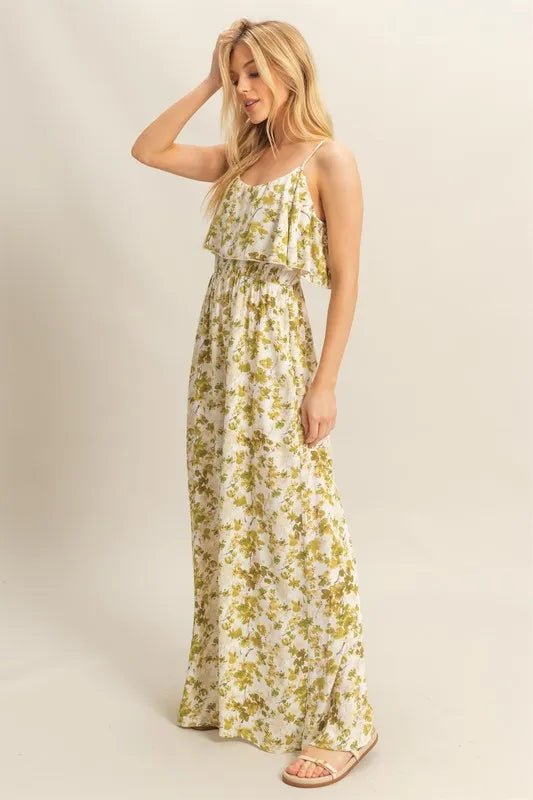  Side view showing the loose fit and movement of the yellow-green jumpsuit, accentuating the comfort and drape of its wide-leg cut.