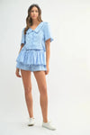 Playful front view of the model wearing the sky blue set, perfect for warm weather style and casual charm.
