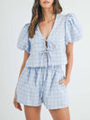 Front view of the sky blue V-neck puff sleeve top and matching shorts set, featuring a relaxed fit and chic puff sleeve design. The light and airy fabric makes it perfect for a breezy summer day.

