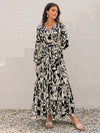 Side view of the floral maxi dress, showcasing the tiered design and long sleeves