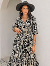 Side view of the floral maxi dress, showcasing the tiered design and long sleeves.