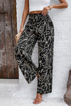 Model wearing Smocked Printed Wide Leg Pants styled for a casual, beach-ready look.